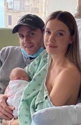 Patrick Kane with his partner and their baby.